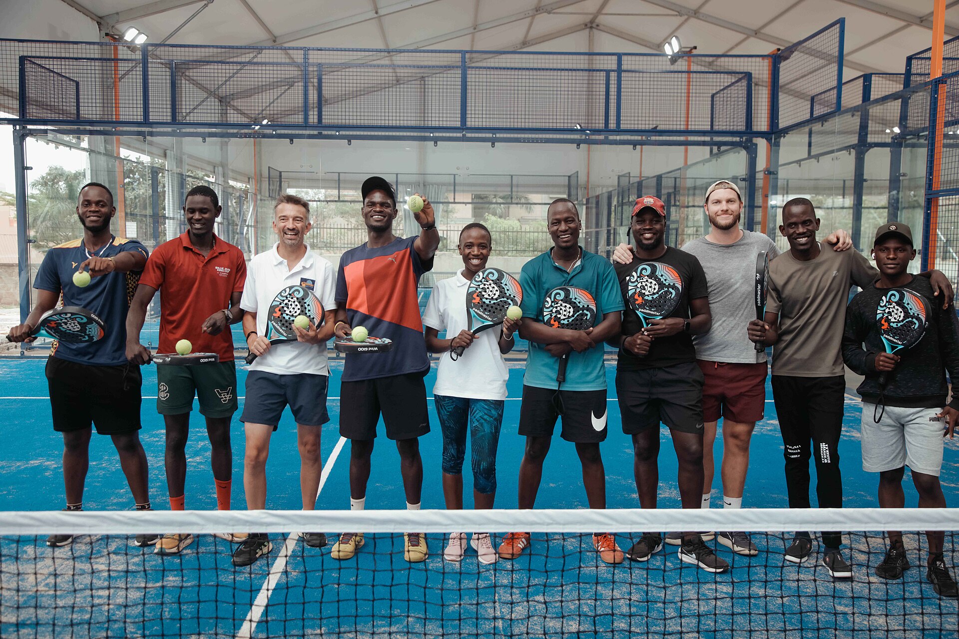 Entrants lined up on court in matching tournament tees